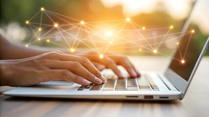 Modern person typing on laptop with abstract digital network overlay glowing brightly
