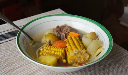 Typical Costa Rican soup called olla de carne with corn, potato, chayote, green plantain, carrot,...