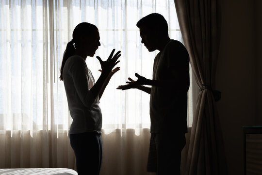 silhouette of a young couple arguing fighting at home, family issues, marriage relationship problems 