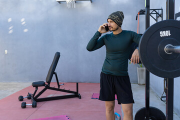 Sportsman talking on the phone during training break