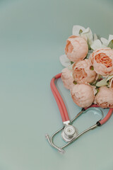 Medical Instruments with flowers on blue Background. photo of a medical hammer, orchidometer,...