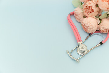 Medical Instruments with flowers on blue Background. photo of a medical hammer, orchidometer,...