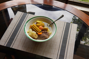 Typical Costa Rican soup called olla de carne with corn, potato, chayote, green plantain, carrot, typical Mexican and Central American food, broth called caldo de res or meat soup