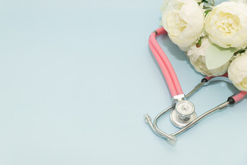 Medical Instruments with flowers on blue Background. photo of a medical hammer, orchidometer,...