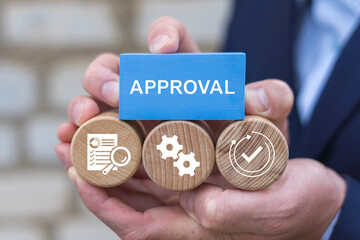 Business person holding wooden blocks with icons sees the word APPROVAL. Approval Efficiency Policy Progress Business Concept. Approved document or agreement.