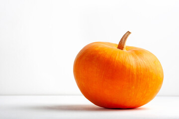 A large orange pumpkin on a white background. Space for text