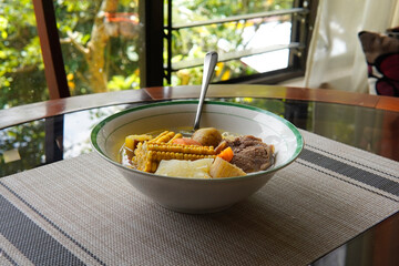 Typical Costa Rican soup called olla de carne with corn, potato, chayote, green plantain, carrot, typical Mexican and Central American food, broth called caldo de res or meat soup