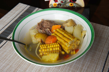 Typical Costa Rican soup called olla de carne with corn, potato, chayote, green plantain, carrot,...