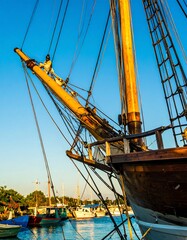 Wooden sailing ship mast in harbor