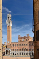 Naklejka premium Torre del Mangia Tower and Palazzo Pubblico-Town Hall across Piazza del Campo Square seen along Costanella dei Barbieri Slope. Siena-Tuscany-Italy-205