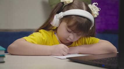 little schoolboy student writes mathematics notebook. child kid solves difficult learning problems....