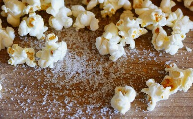 Homemade popcorn with salt on the wooden table in the kitchen