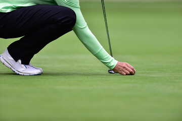 Detail of a golfer on a green 