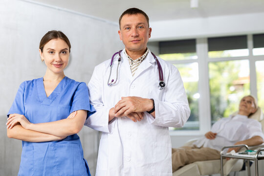 Doctors or surgers with paper board or patient folder (OPD) looking at camera.