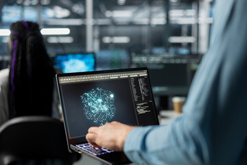 Close up of admin using laptop in data center, optimizing hardware for AI tasks. Server room IT...