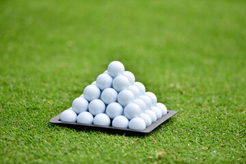 Piramid of golf balls on a golf curse 