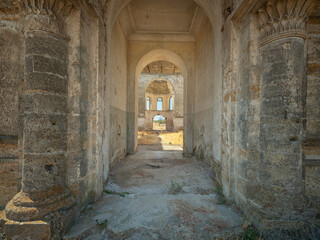 view inside interior of abandoned cathedral through main entrance with columns