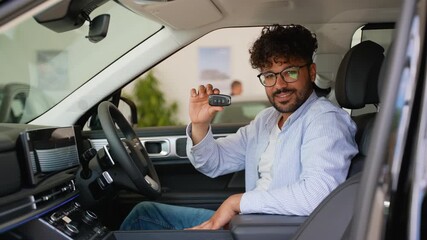 Happy customer showing new car key inside dealership