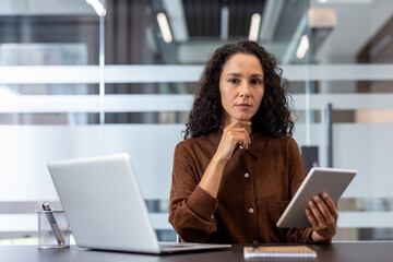 Professional woman working with tablet in a modern office environment