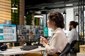 Employees sharing ideas on a web video conference call at the workstation, discussing about project...