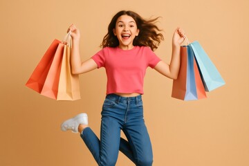 Portrait of a cheerful young woman jumping while holding colorful shopping bags, expressing happiness and excitement after a successful shopping spree