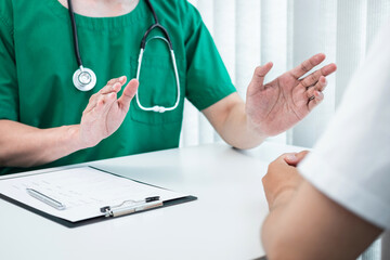 Doctor presenting with the patient and checking results on report and prescription about the...