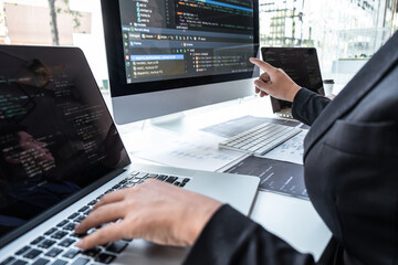 Team of developer programmer working on project in software development computer in IT company office, Writing codes and data code website and coding database technologies to find problem solution