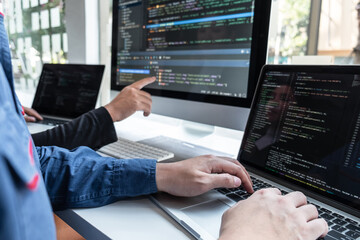 Professional Team of programmer working on project in software development computer in IT company office, Writing codes and data code website and coding database technologies on new Application