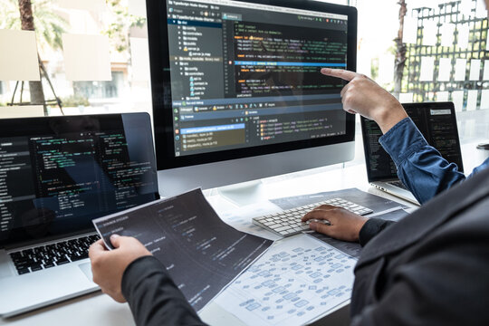 Professional Team of programmer working on project in software development computer in IT company office, Writing codes and data code website and coding database technologies on new Application - Powered by Adobe