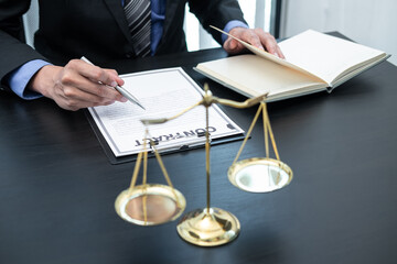 Male lawyer working with legal case document contract in office
