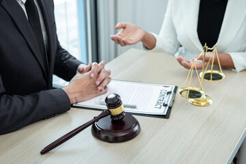 Male lawyer or counselor discussing negotiation legal case with client meeting with document...