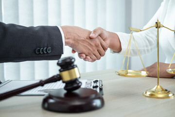 Male lawyer shaking hands with client after good deal negotiation cooperation meeting in courtroom