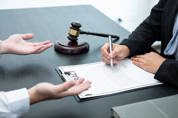 Male lawyer or counselor discussing negotiation legal case with client meeting with document contract in office, law and justice, attorney, lawsuit concept