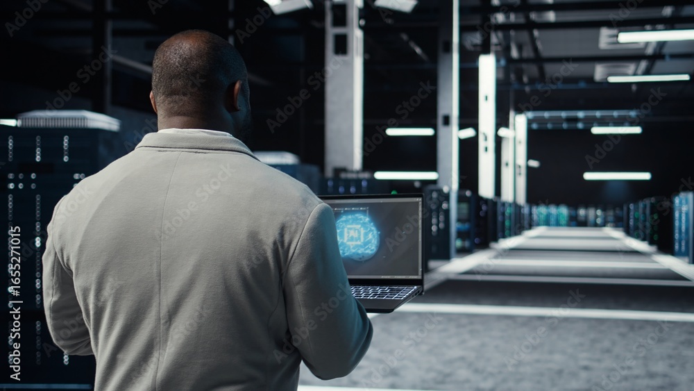 Poster it expert walking in server hub using laptop to enhance ai model accuracy. data center technician us