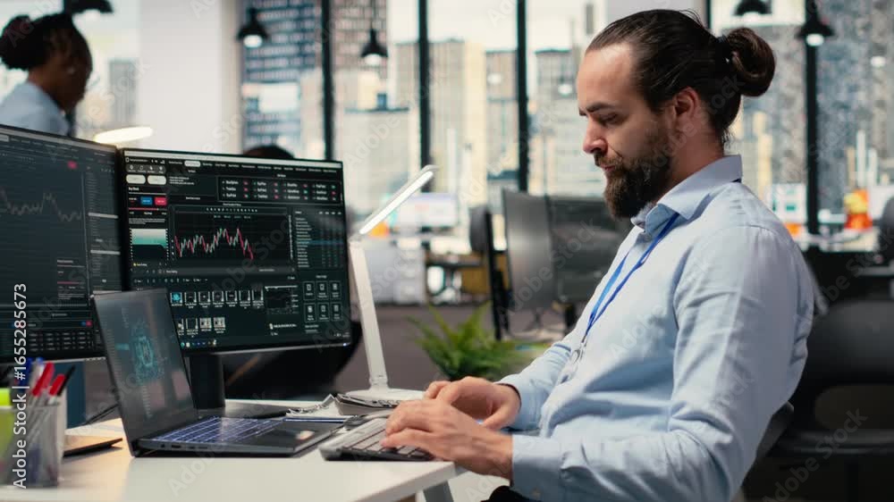Poster trader in office leverages artificial intelligence on laptop to interpret charts, optimizing buying 
