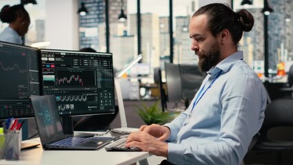 Trader in office leverages artificial intelligence on laptop to interpret charts, optimizing buying and selling. Stockbroker uses deep learning automatization on notebook to maximize profits, camera B