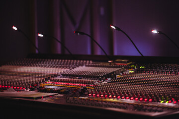 Professional Audio Mixing Console with Illuminated Controls and Equipment