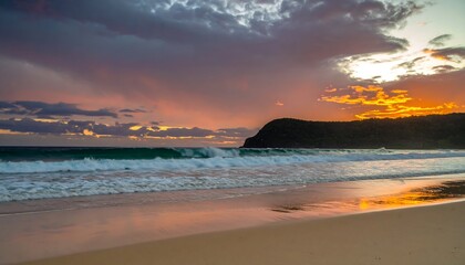Fototapeta premium A serene beach scene at sunrise, featuring vibrant hues of orange and pink reflected on the tranquil sand, with crashing waves and a dramatic sky.