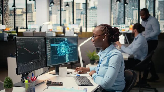 Trader in office leverages AI technology on PC to interpret analytics charts, optimizing buying and selling. African american woman uses deep learning automatization to maximize profits, camera A