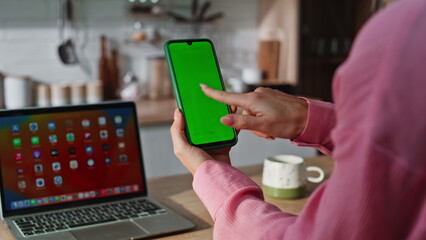 Unknown girl touching mockup cellphone desk closeup. Woman tapping green screen