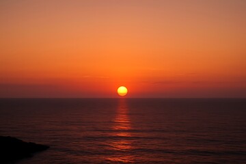 Majestic Sunset Over the Tranquil Ocean Waters with Vivid Orange Sky and Gentle Waves Reflecting the Light of the Setting Sun a Perfect Moment of Natural Beauty