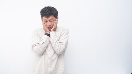 Asian man wearing shirt feeling cold against isolated white background
