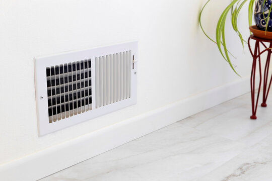 Supply air vent installed in the room. Air register placed near the floor
