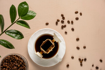 Drip bag of fresh drink in a glass with coffee beans. Drip coffee using a paper type filter.