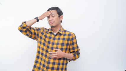 Asian young man showing stress gesture with hand touching forehead, studio shot