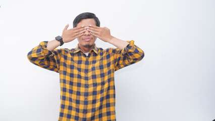 Asian young man with hands cover close eyes isolated over gray background