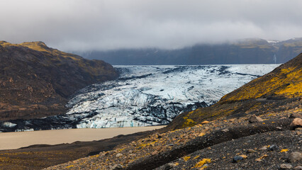 Scenic view of huge Svinafellsjokull glacier in southern Iceland during spring time with overcast sky.