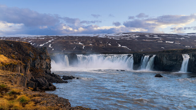 Scenic view of Goafoss curved tall water falls in Iceland under twilight.