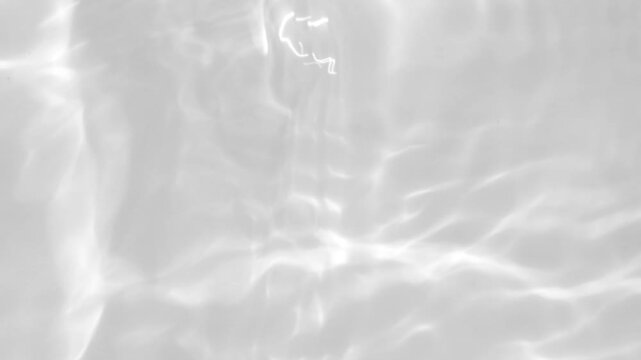 Soft light reflections on a clear water surface, creating a serene abstract pattern. Minimalist and bright visual capturing calmness, clarity, and motion