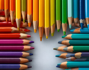 Obraz premium Rainbow collection of colored pencils arranged in corner frames on white background. Variety of shades, bright colors, perfect for education, creativity, art projects. Copy space available for text.